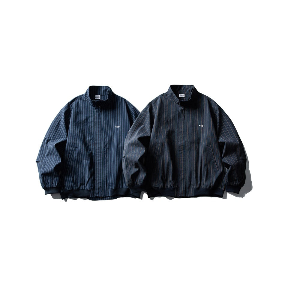 Two dark striped zip-front jackets shown from the front, one blue and one nearly black, with stand collars and elastic cuffs.