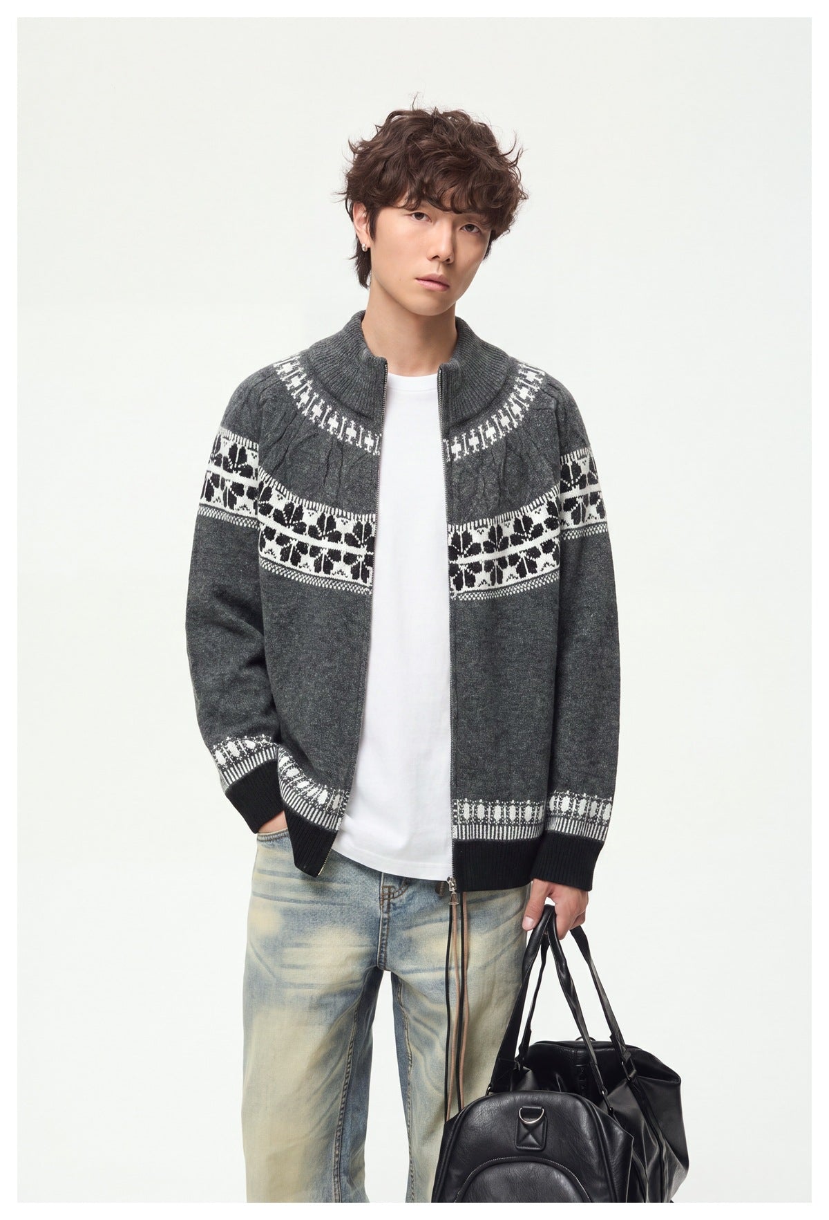 Front view of a model wearing an open charcoal full-zip knit cardigan with a high collar and white patterned bands.