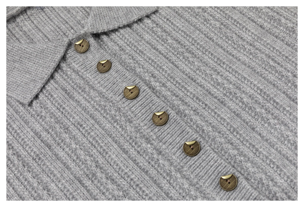 Close-up of a light gray rib-knit cardigan collar and placket with antique-gold buttons.