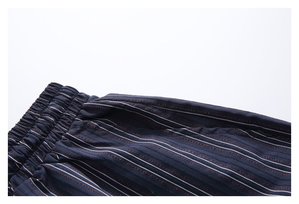 Close-up of the elastic waistband and striped fabric of a dark navy garment.