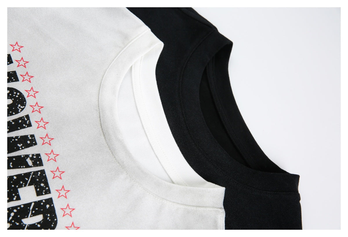 Close-up of white and black crew-neck T-shirts with partial black lettering and red star prints.