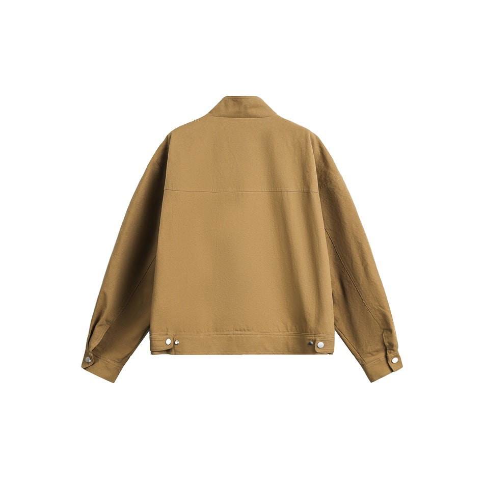 Back view of khaki jacket with stand collar, back yoke seam, snap hem tabs and snap cuffs