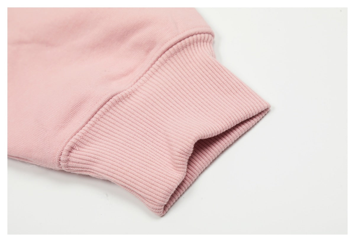 Close-up of a pale pink sleeve ending in a wide ribbed cuff.