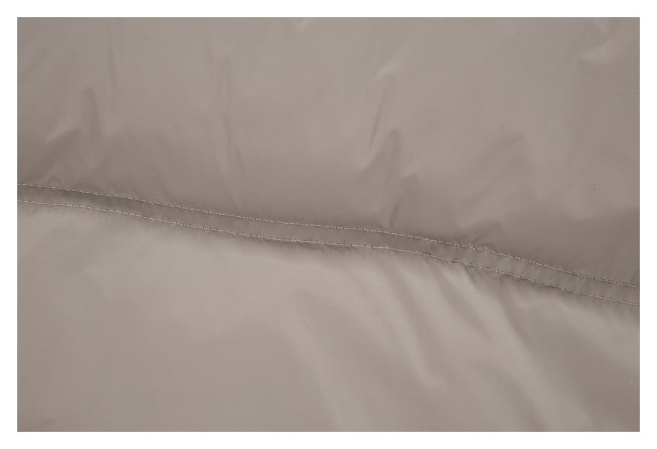 Close-up of a double-stitched seam on taupe jacket fabric.