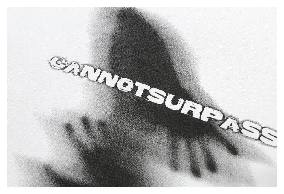 Close-up of a black-and-gray graphic and bold English lettering printed on white fabric.
