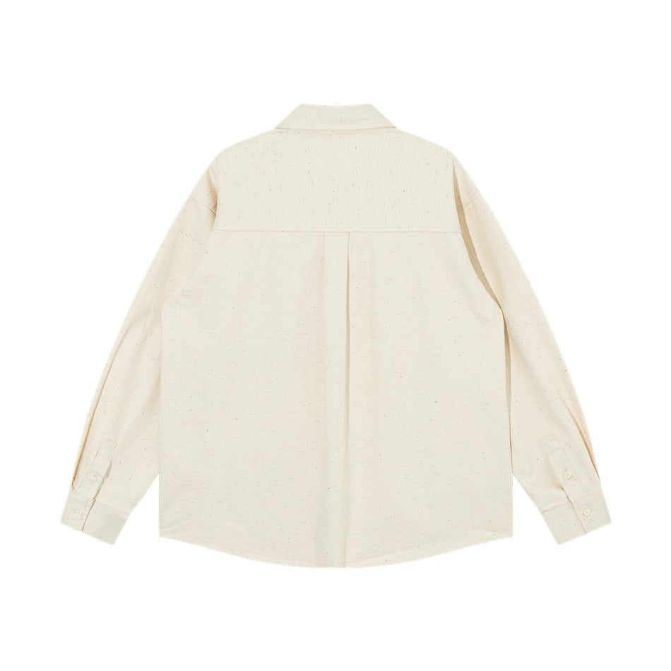 Back view of beige speckled button-up shirt showing yoke and center box pleat, flat lay