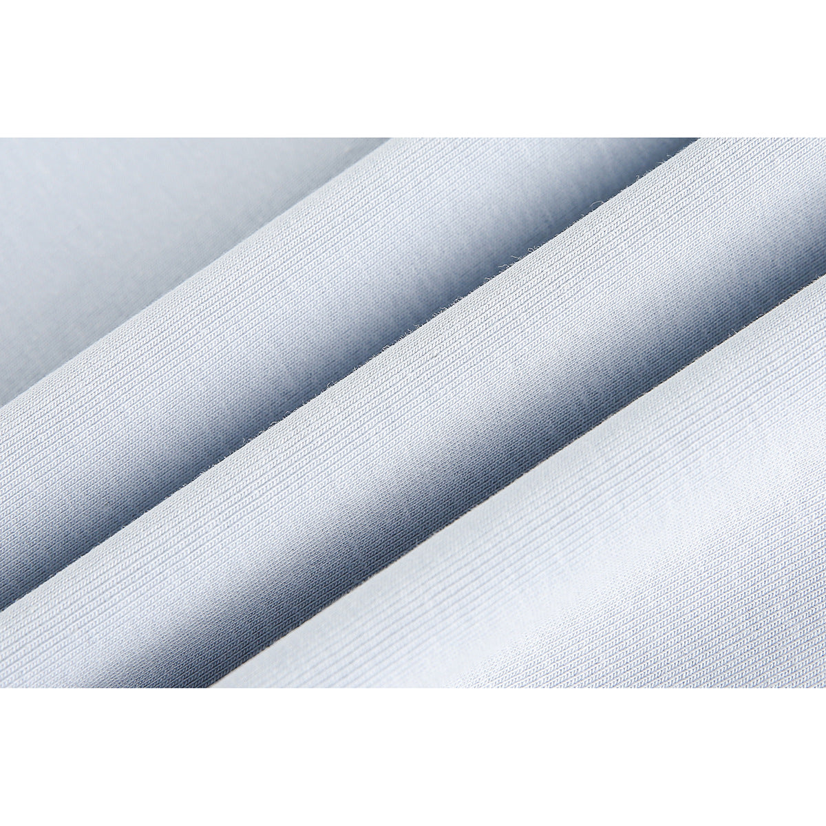 Close-up of pale blue fabric folded to show its fine knit texture.