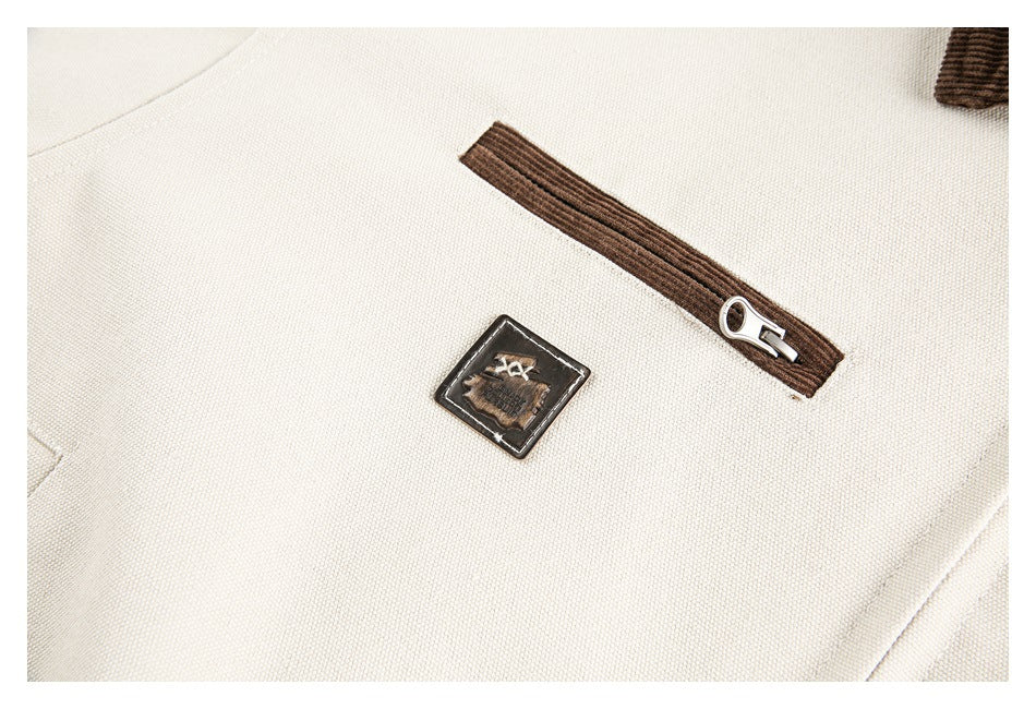 Close-up of cream textured fabric with a brown zipper and a small rectangular patch.