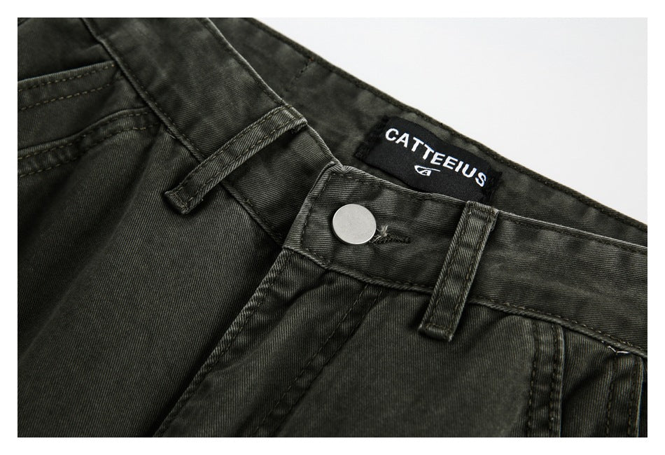 Close-up of charcoal trouser waistband, button, belt loops and sewn brand label.