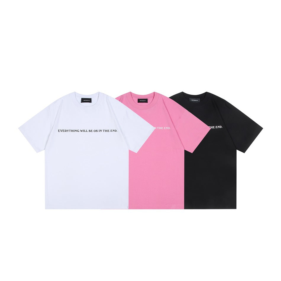 Three short-sleeve crew-neck T-shirts in white, pink, and black, each with a small English slogan across the chest.