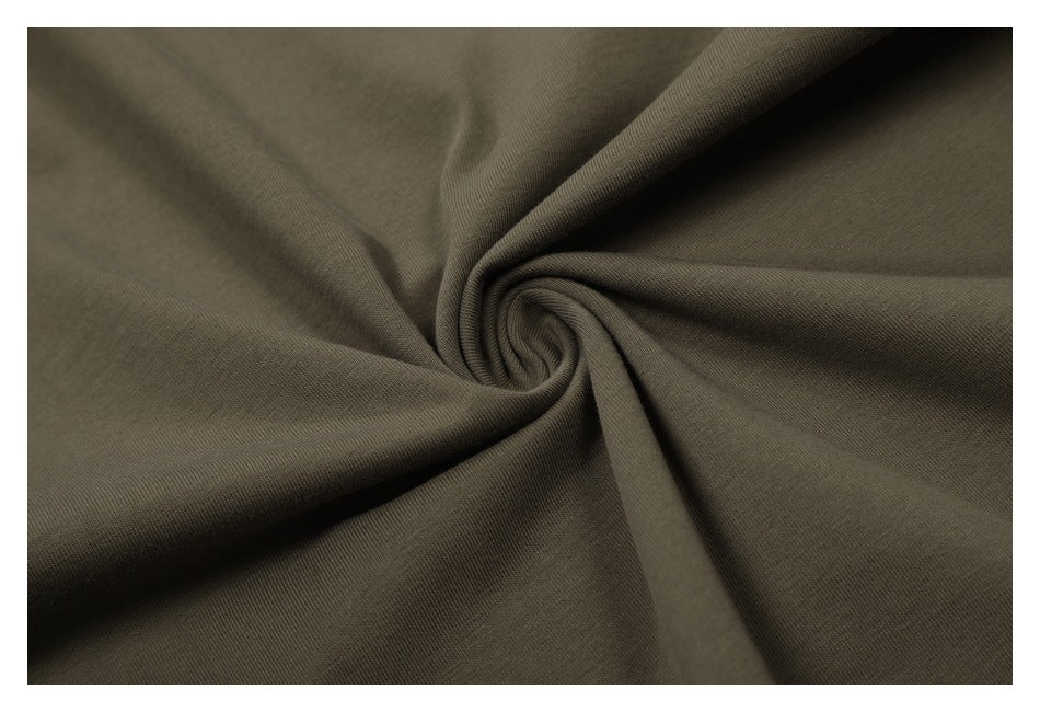 Close-up of olive-brown fabric gathered into a swirl, showing its surface texture.