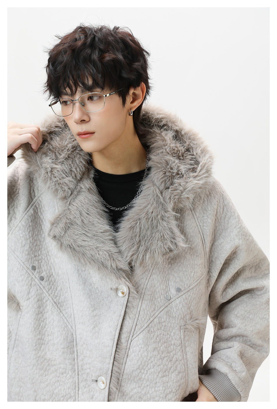 Close-up of the light gray jacket's plush fur collar, quilted texture, buttons, and curved front seams.