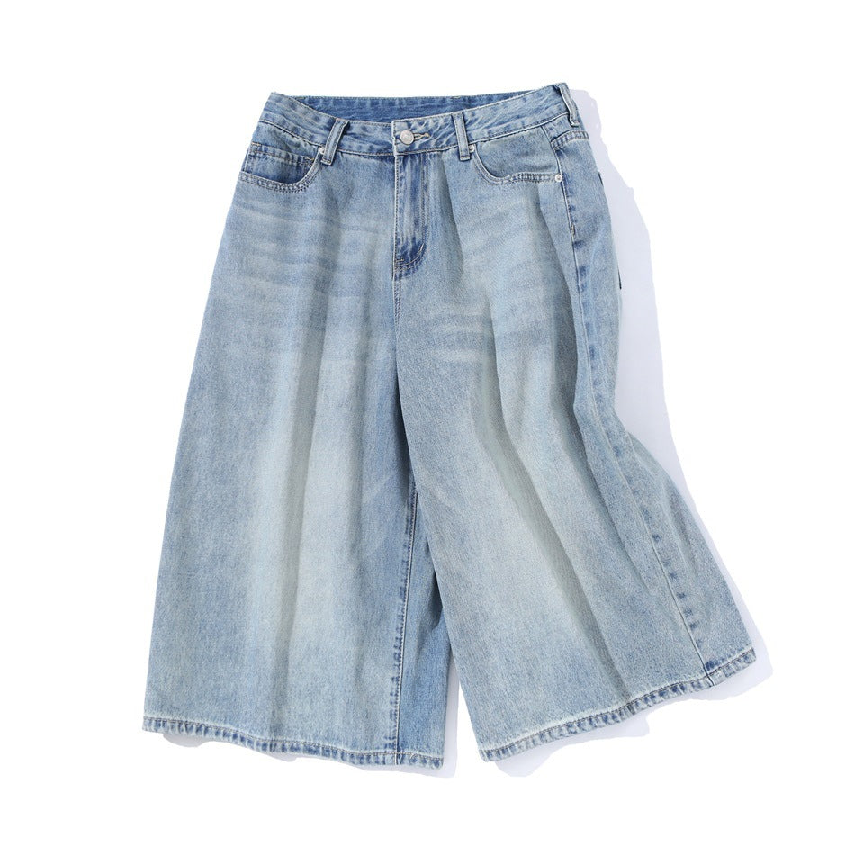 Light blue wide-leg cropped denim pants laid flat at an angle, showing front and side seam