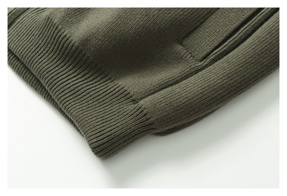 Close-up of an olive-gray ribbed garment edge with a folded seam.