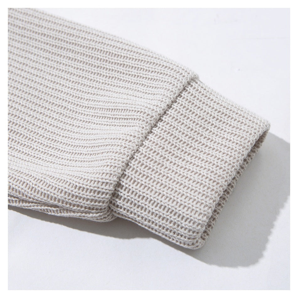 Close-up of the wide rib-knit cuff on a light beige cardigan sleeve.