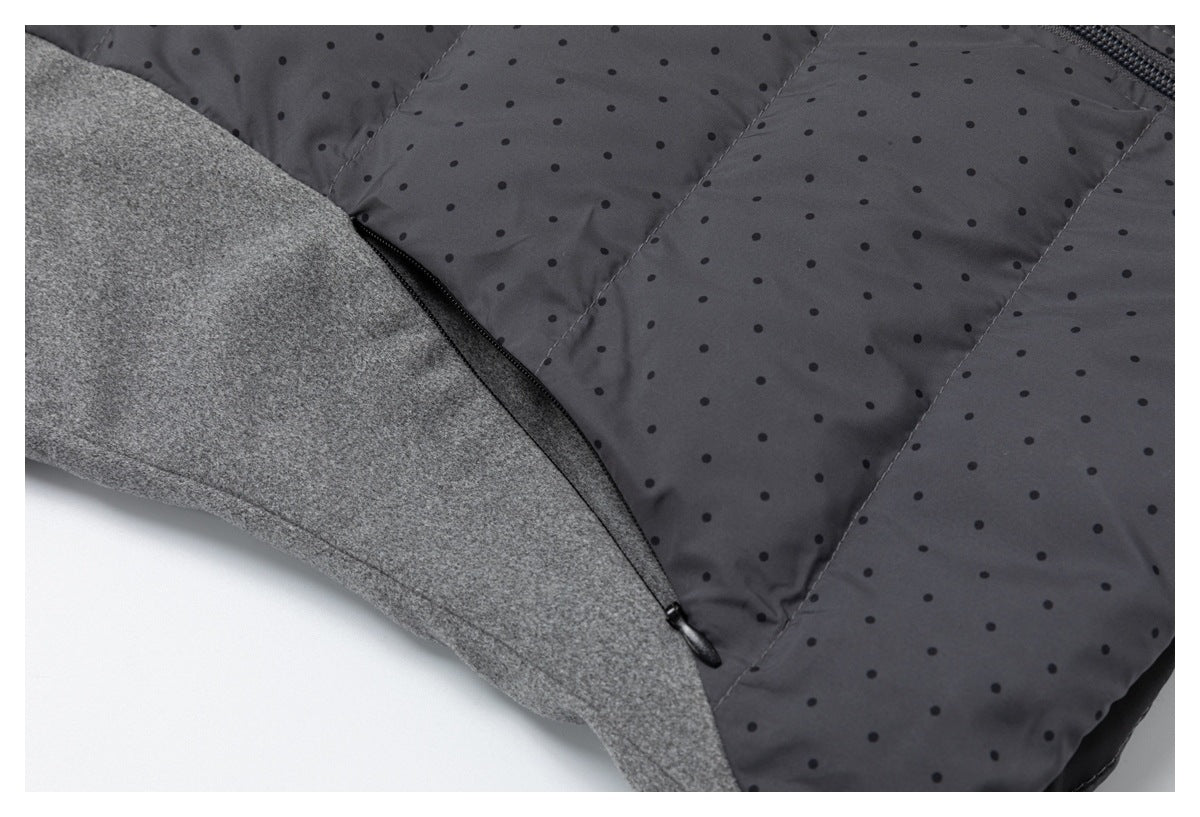 Close-up of the black side zipper joining the gray sleeve and charcoal dotted jacket panel.