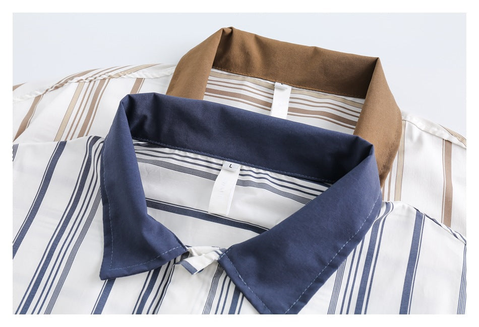 Close-up of navy and tan collars on white striped shirts, with the navy collar in front.