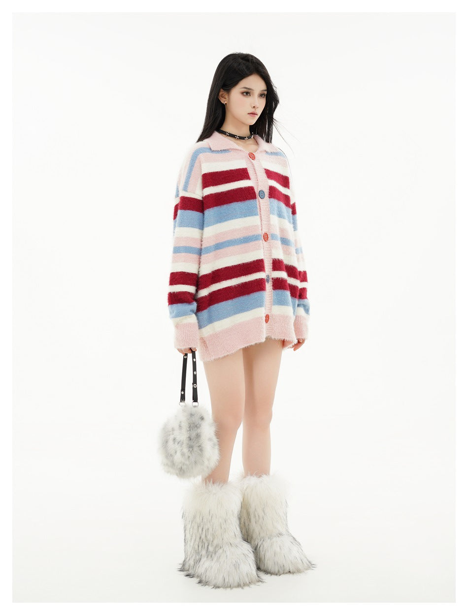 Model wearing an oversized pink cardigan with horizontal burgundy, white, and blue stripes, front view.