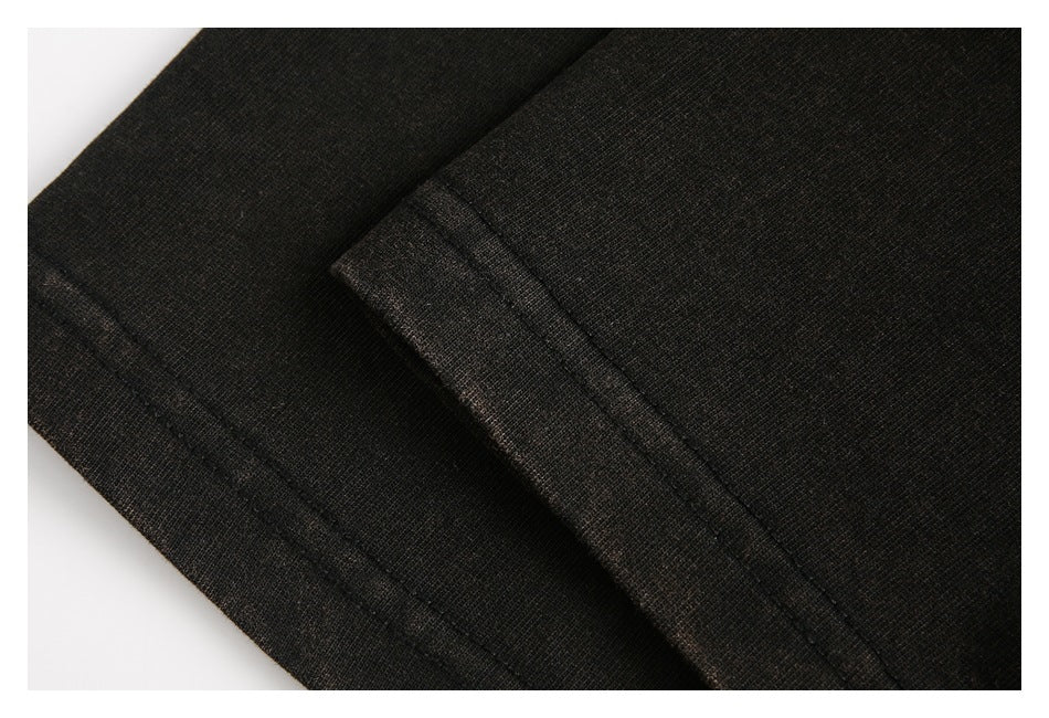 Close-up of black garment seams and folded fabric edges.