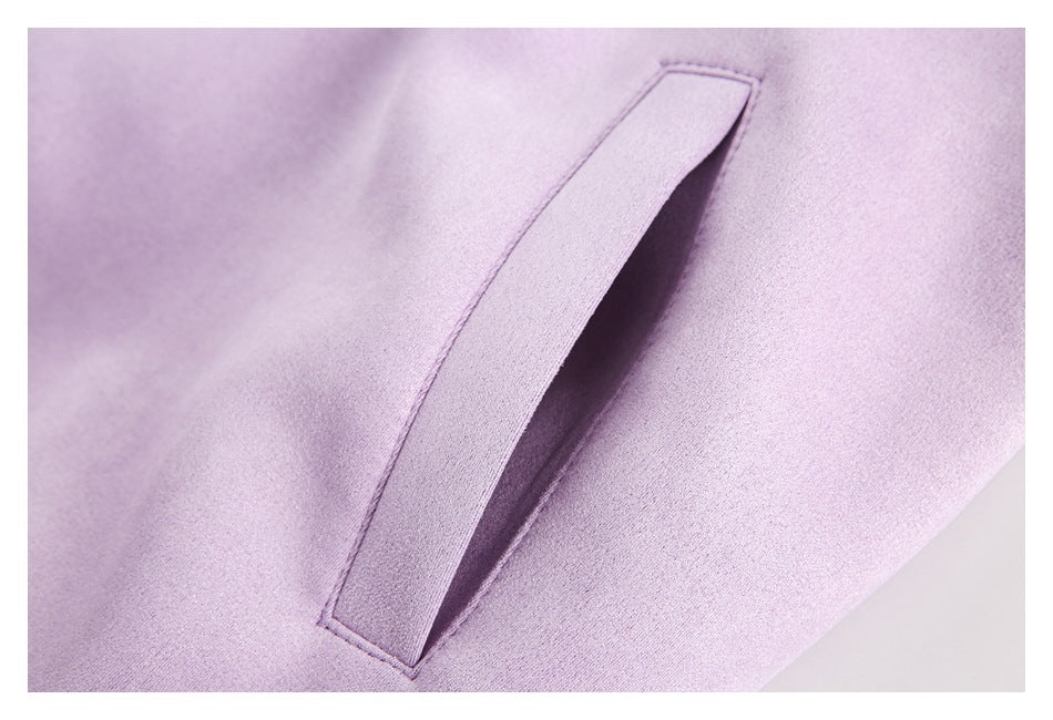 Close-up of a slanted welt pocket on the lilac jacket.