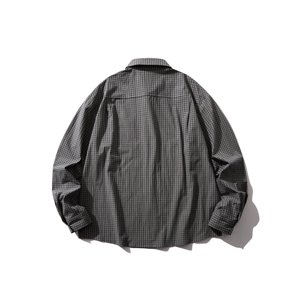 Back view of dark small plaid long-sleeve shirt with back yoke seam, flat lay