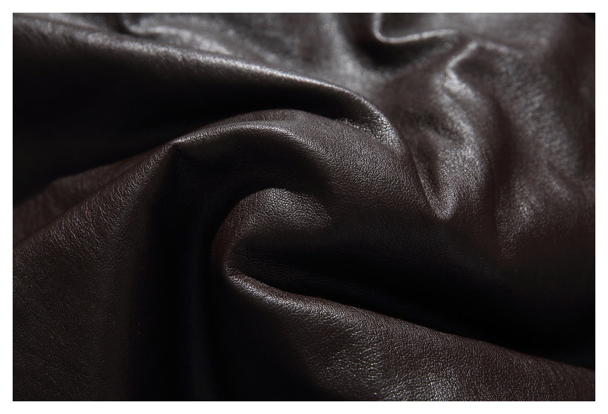 Macro view of the dark brown jacket's softly folded, pebbled surface.