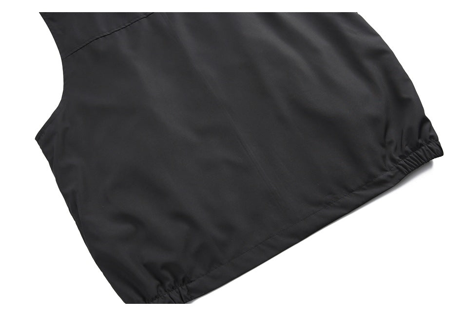Back view of a black sleeveless jacket laid flat, with a high collar and gathered hem.
