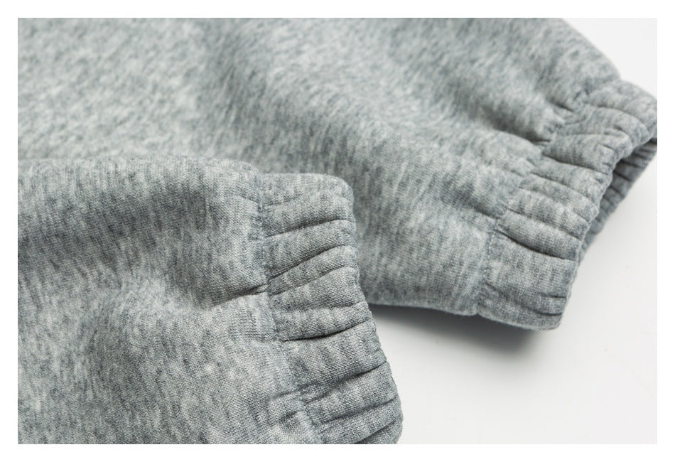 Close-up of gathered elastic cuffs on a heather gray garment.