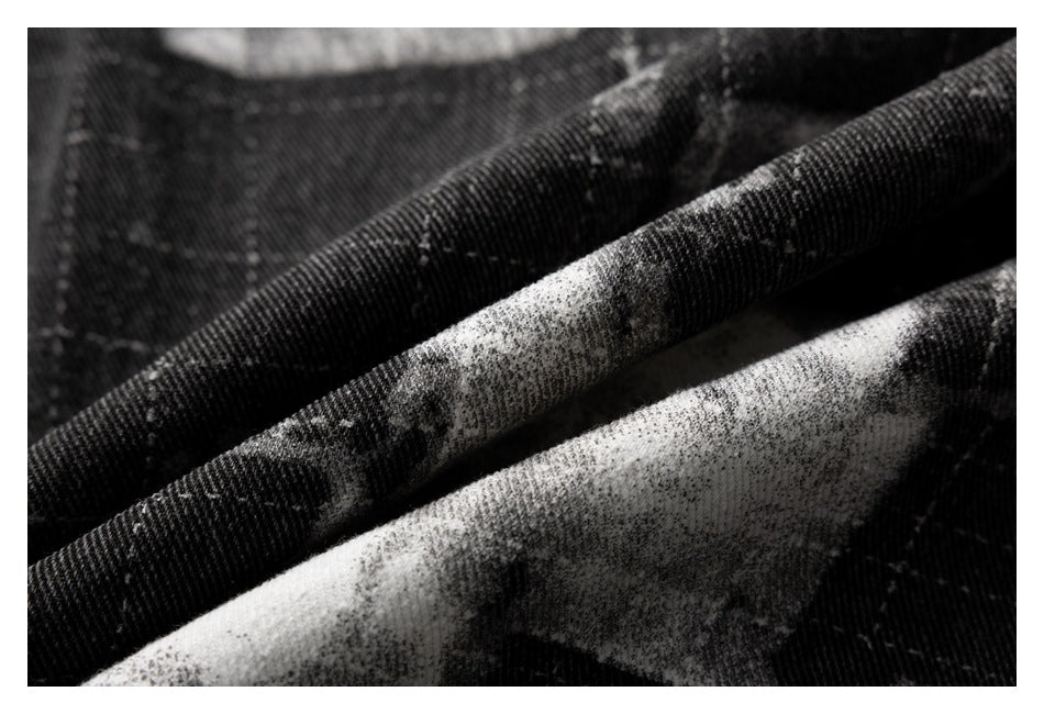 Close-up of black and gray patterned fabric with a visible diagonal weave and soft folds.