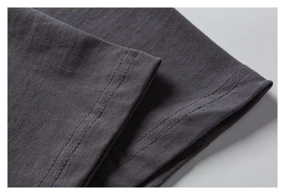Close-up of the charcoal T-shirt's sleeve and double-stitched hem.