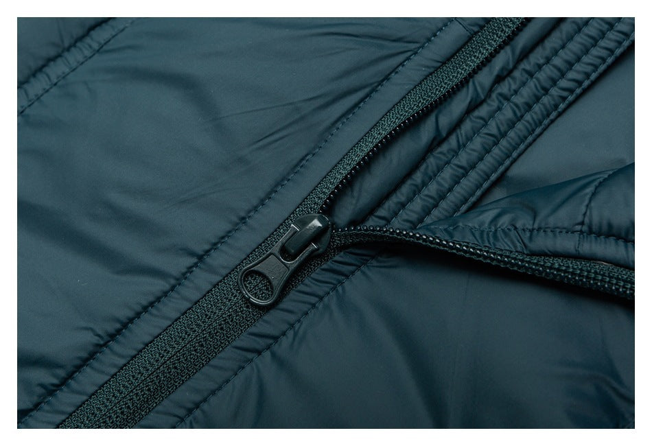 Close-up of the teal jacket's black front zipper and stitched placket.