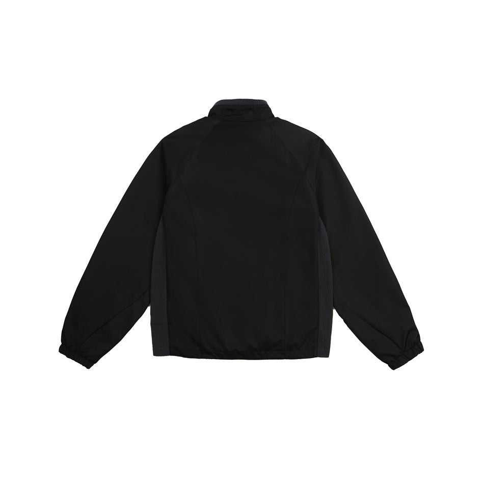 Back view of a black jacket with raglan sleeves, elastic cuffs, and dark mesh side panels.
