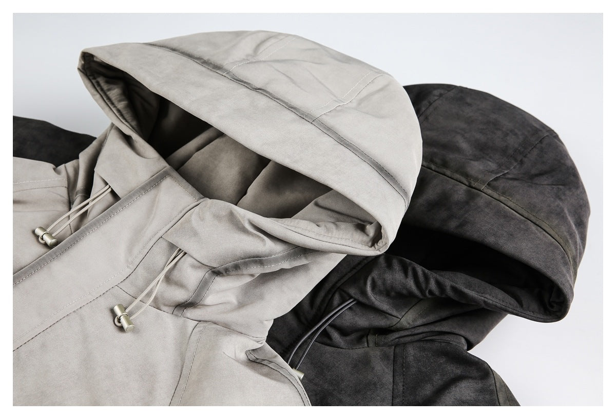 Close-up of two hooded jackets in light gray and charcoal, showing panel seams and adjustable drawcords.