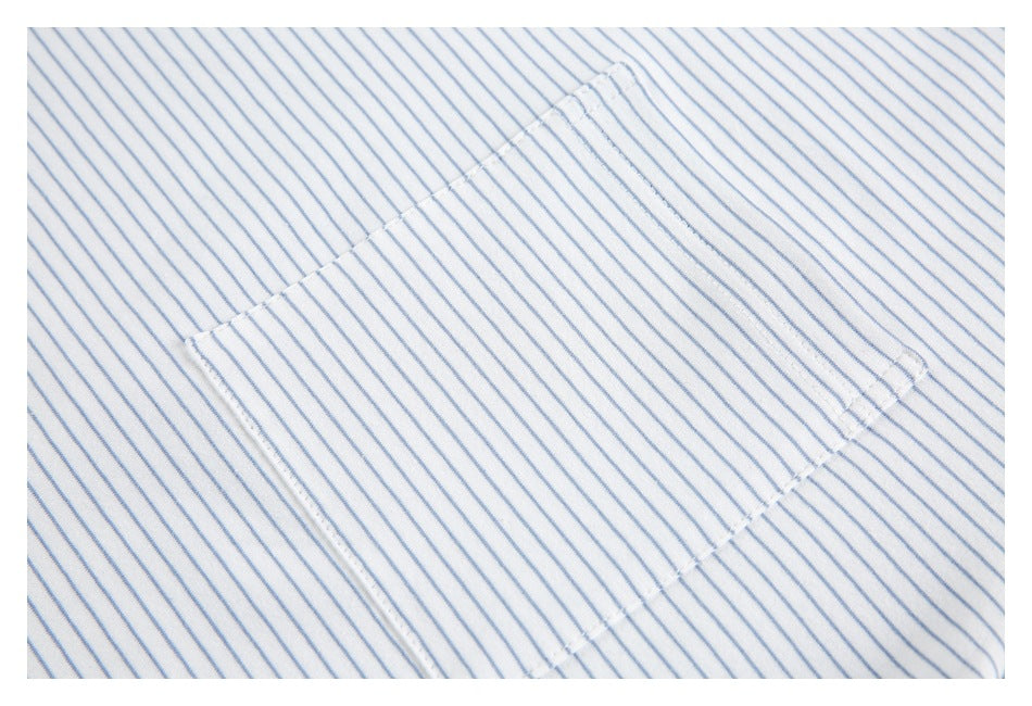 Close-up of a patch pocket on a white shirt with thin blue stripes.