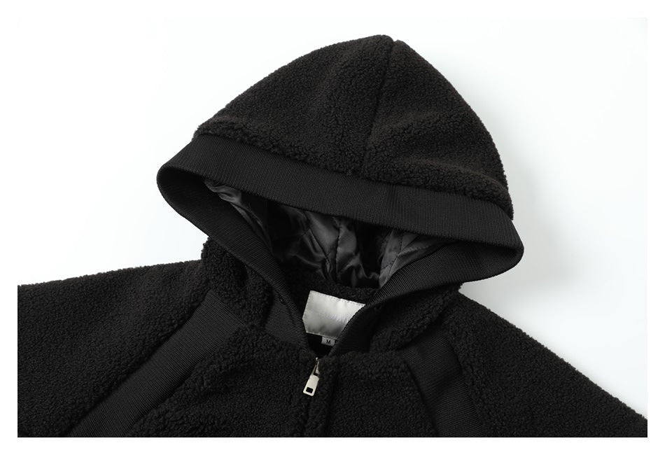 Close-up of the black plush jacket's hood, smooth lining, neckline, and front zipper.