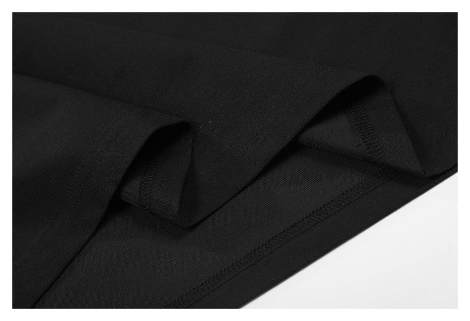 Close-up of the black garment's folded inner hem and overlock stitching.