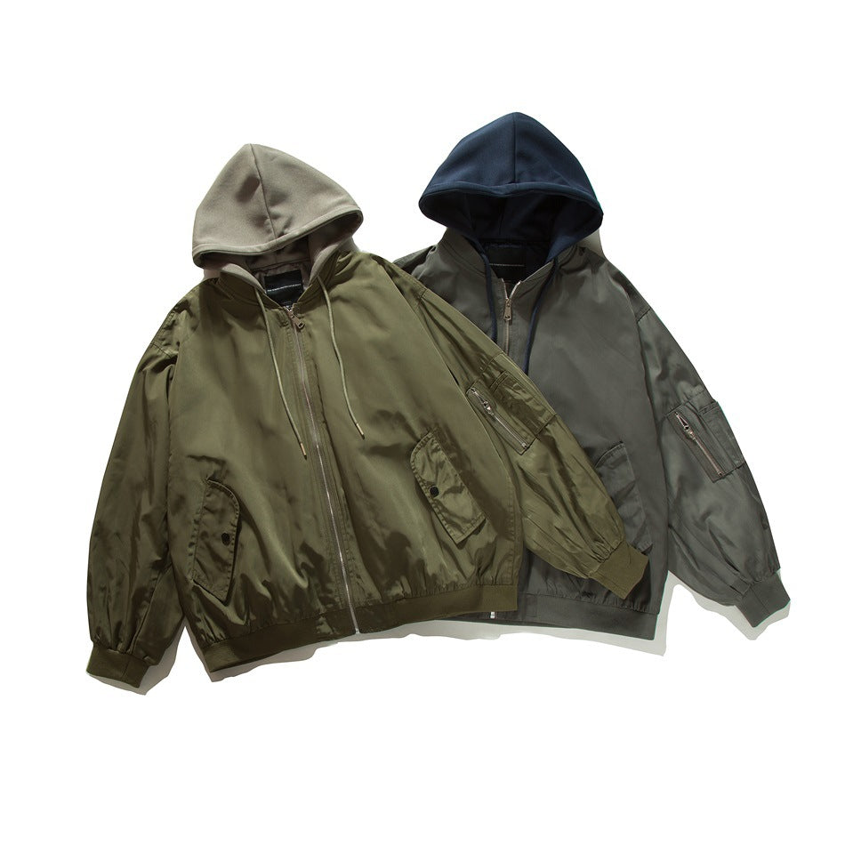 Two hooded bomber jackets displayed together: an olive jacket with a pale gray hood and a gray-olive jacket with a navy hood.