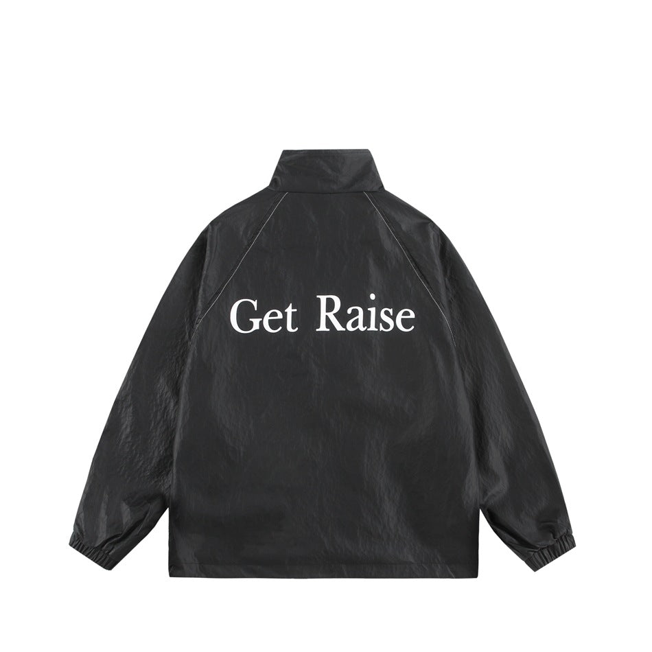 Full back view of a black jacket with a stand collar, elastic cuffs, raglan seams, and white “Get Raise” lettering.