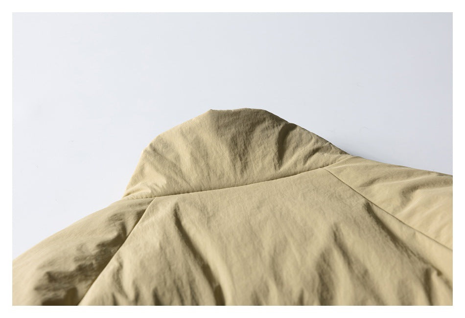 Close-up of the khaki jacket's upper back and shoulder seam.