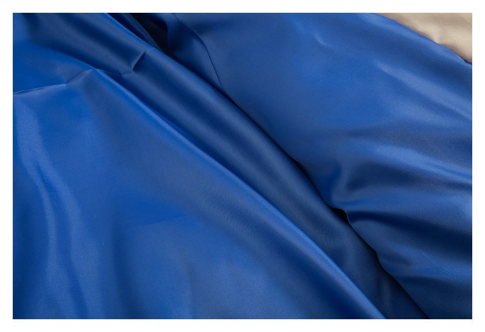 Close-up of the jacket's smooth blue lining beside a small section of beige outer fabric.
