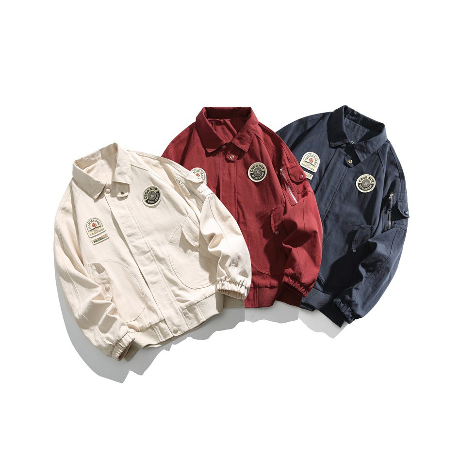 Three laid-out jackets in cream, burgundy and dark navy, each with chest patches, large pockets and elastic cuffs.