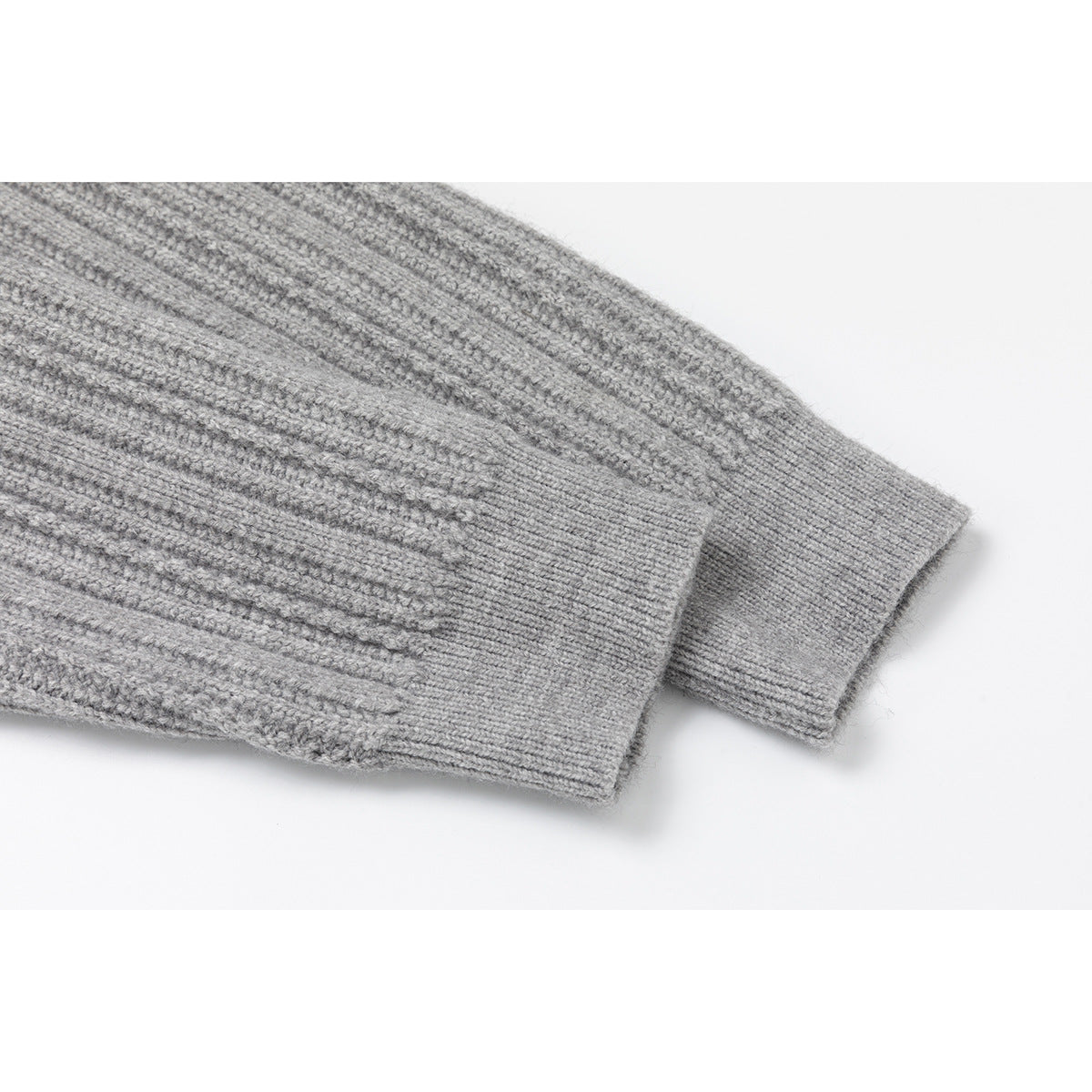 Close-up of two gray rib-knit sweater cuffs resting one over the other.