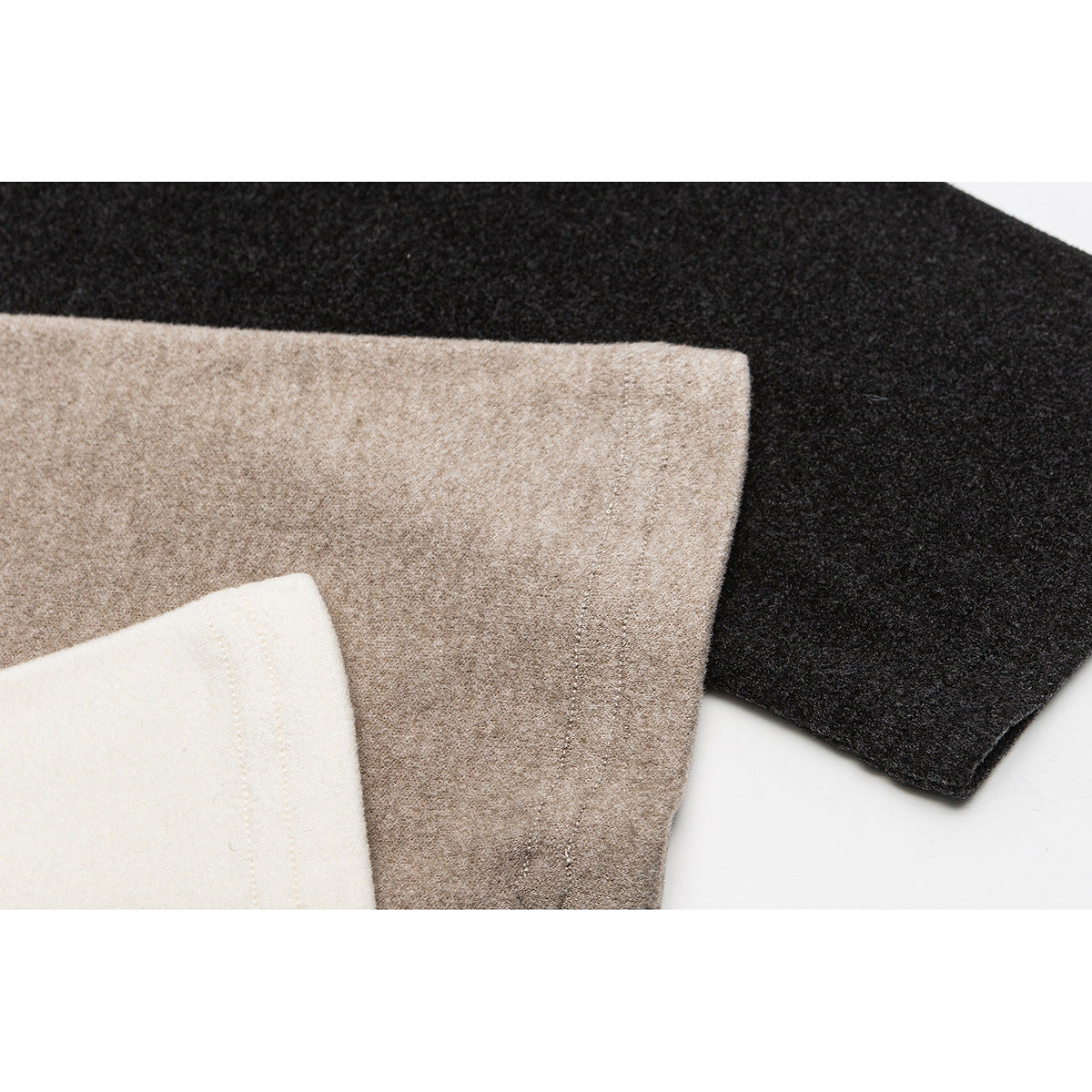 Close-up of cream, taupe, and charcoal shirt fabric sections with visible stitching.