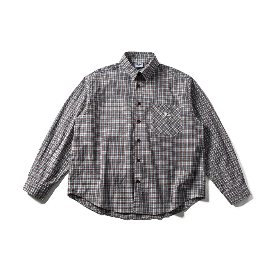 Flat lay front of a long-sleeve red and blue plaid button-up shirt with a chest pocket and maroon buttons