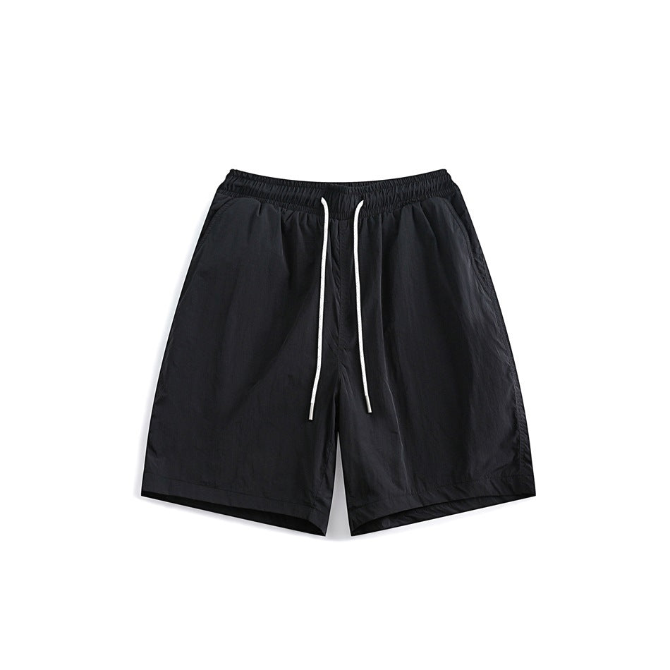 Black drawstring shorts with elastic waistband and side pockets, front flat view