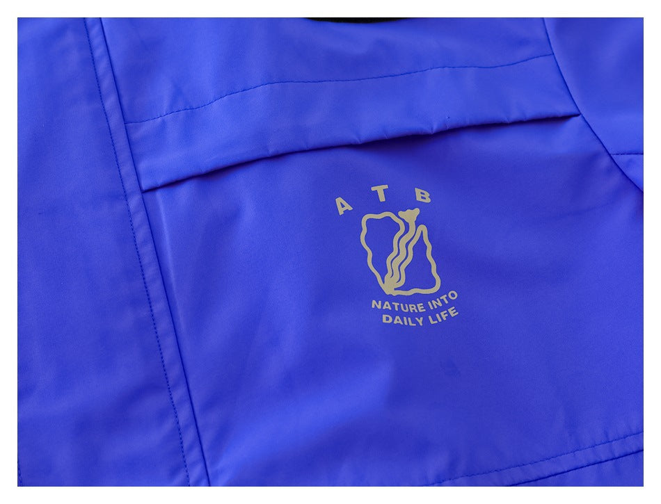 Close-up of a gold-colored emblem and English text printed on the blue jacket.