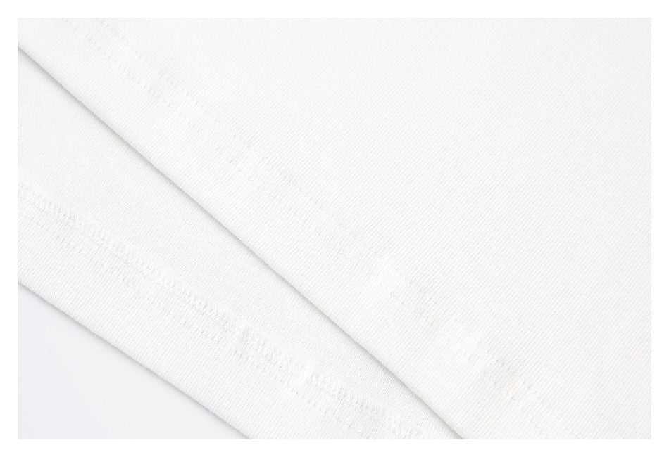 Close-up of the white T-shirt’s fabric and stitched hem.