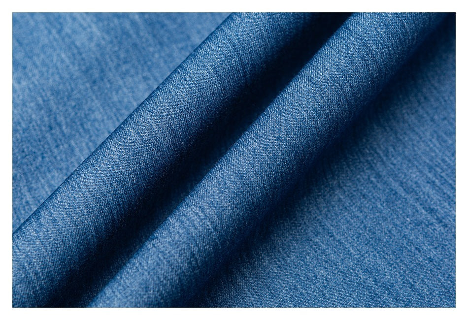 Close-up of blue denim fabric draped into soft folds.