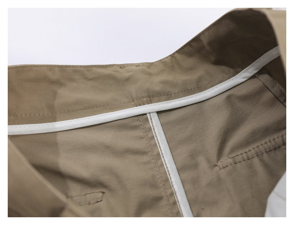 Inside view of khaki trousers showing the waistband lining and white seam binding.