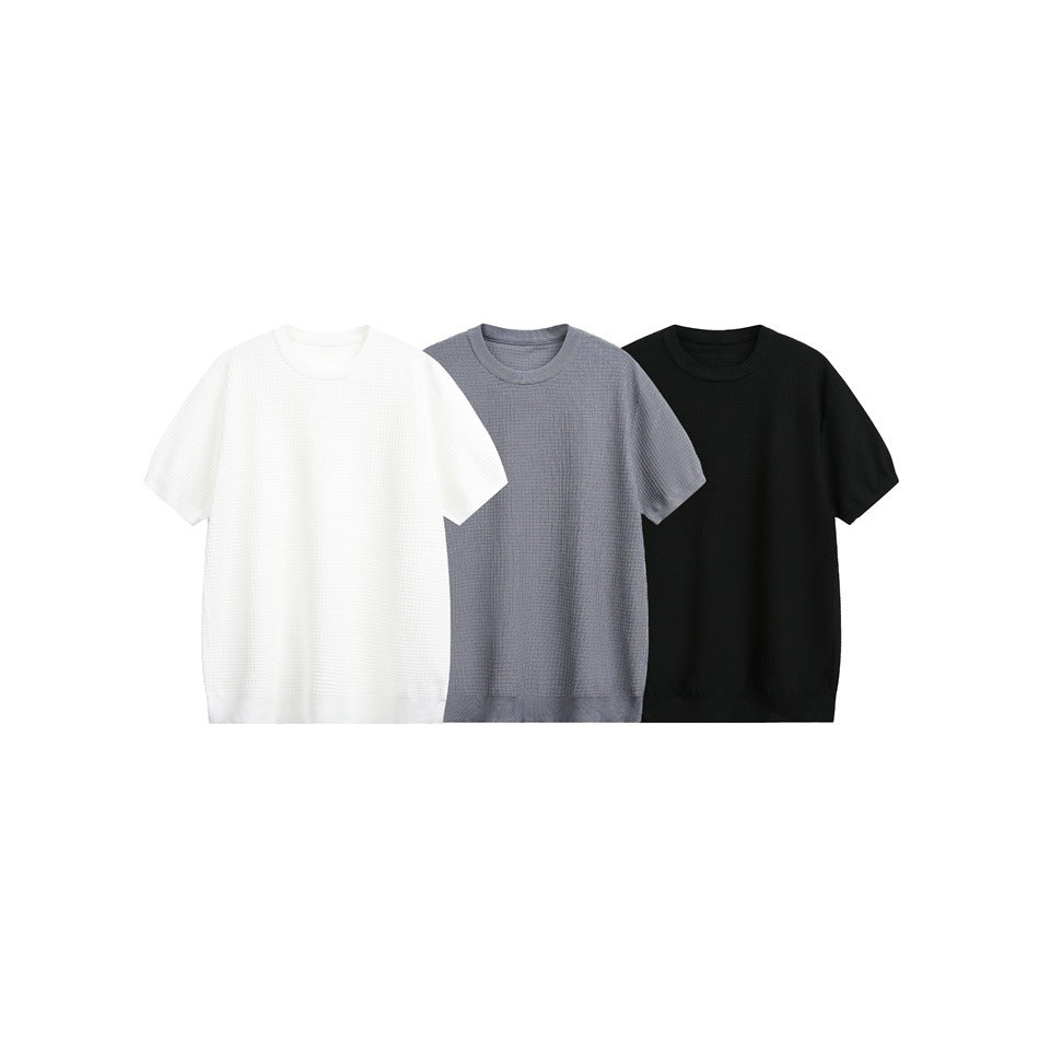 Three short-sleeve textured crew-neck shirts shown together in off-white, gray, and black.